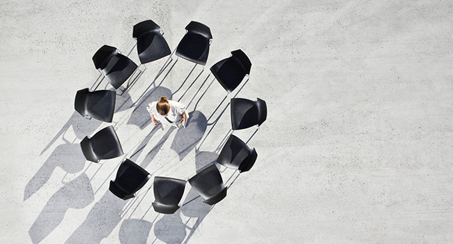 Chairs form a circle around a worker. 